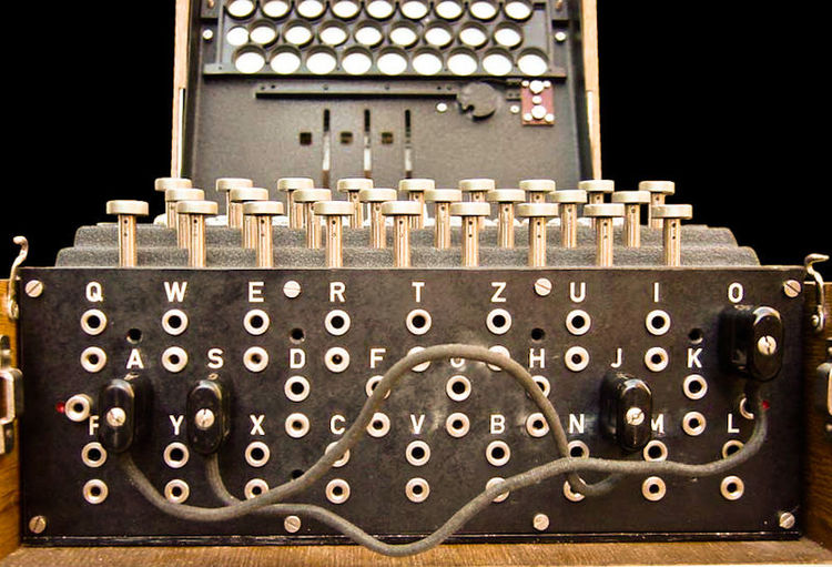 The plugboard is positioned at the front of an Enigma machine, below the keys.
